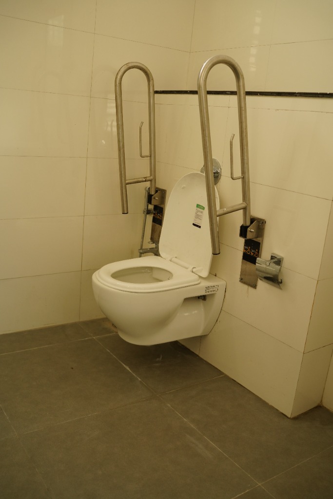 Close-up of wheelchair-accessible grab bar system at VIBGYOR Hinjewadi